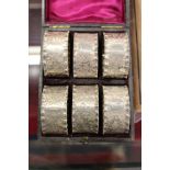 A cased set of six engraved silver plated plated napkin rings.