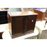 An Edwardian mahogany table top two door cabinet.