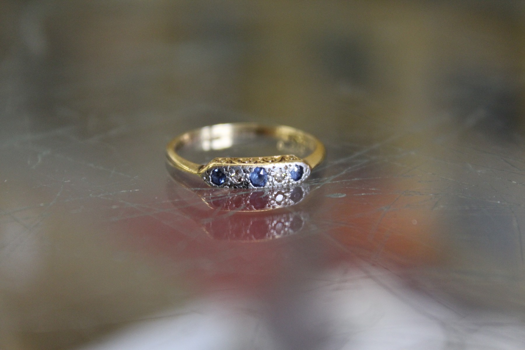 An 18ct gold, platinum, diamond and sapphire ring.