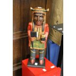 A carved and painted wood figure.