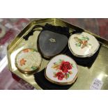 Four decorative ladies' compacts.