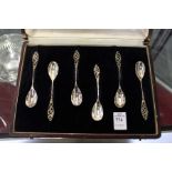 A cased set of six coffee spoons with pierced handles.