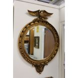 A good large Regency design circular wall mirror with eagle cresting.