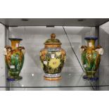 A Majolica style pottery jar and cover and a pair of similar vases.