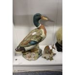A large painted pottery model of a mallard and a similar model of a bird.