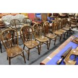 A SET OF EIGHT EARLY 20TH CENTURY BEECH AND ELM WHEELBACK DINING CHAIRS. 3ft 0ins high x 1ft 3ins