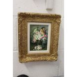 A still life of flowers in a vase, oil on board, in a decorative gilt frame.