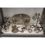 A plated candelabra, a tray and other items.