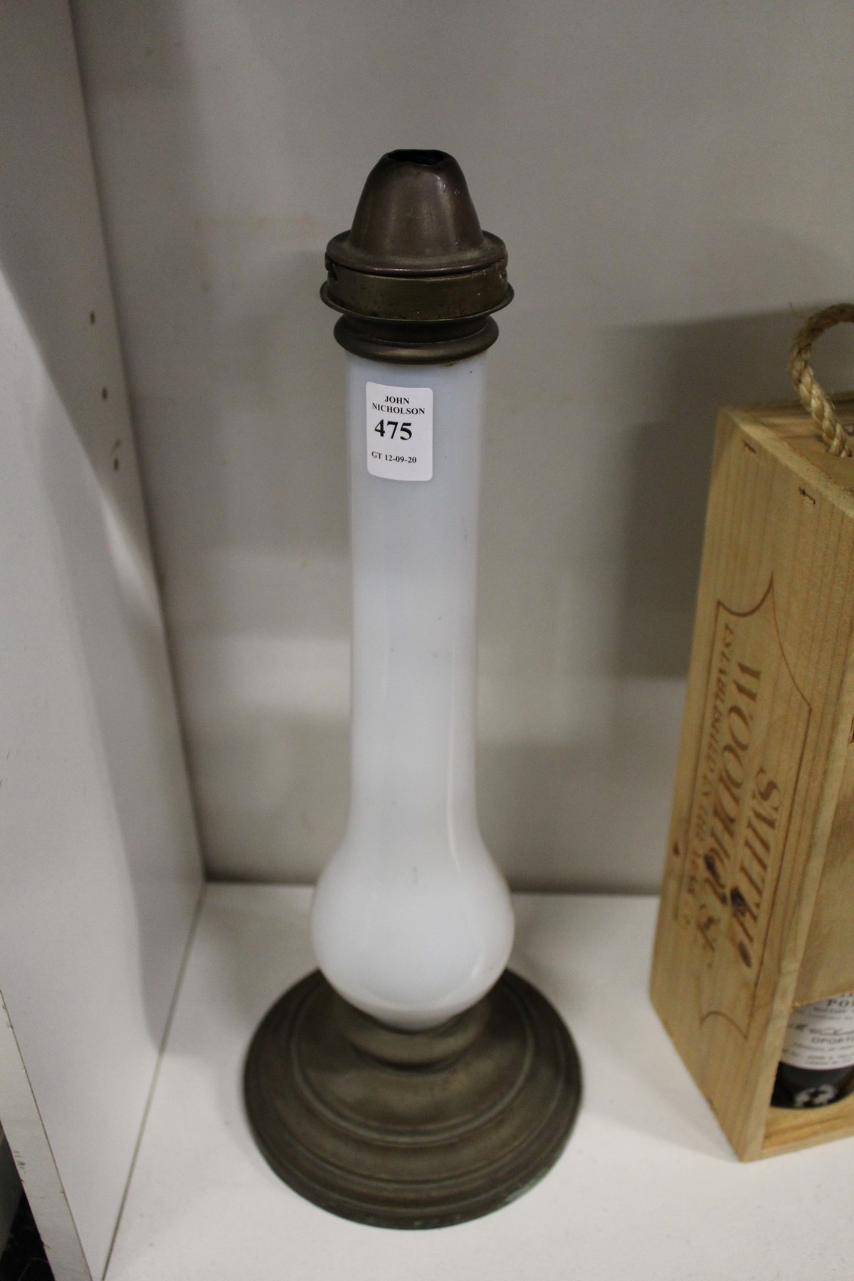 An opaque glass and brass lamp base.