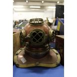 A small copper and brass model of a diver's helmet.