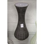 A stylish vase with engraved decoration.