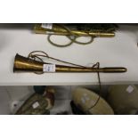 A brass hunting horn.