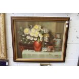 A still life of flowers in a red vase with other items on a table, oil on canvas.