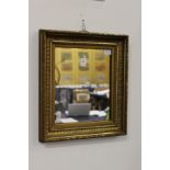 A small gilt framed mirror.
