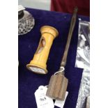 A turned wood stirring stick and an egg timer.