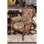 A pair of Victorian style upholstered armchairs.