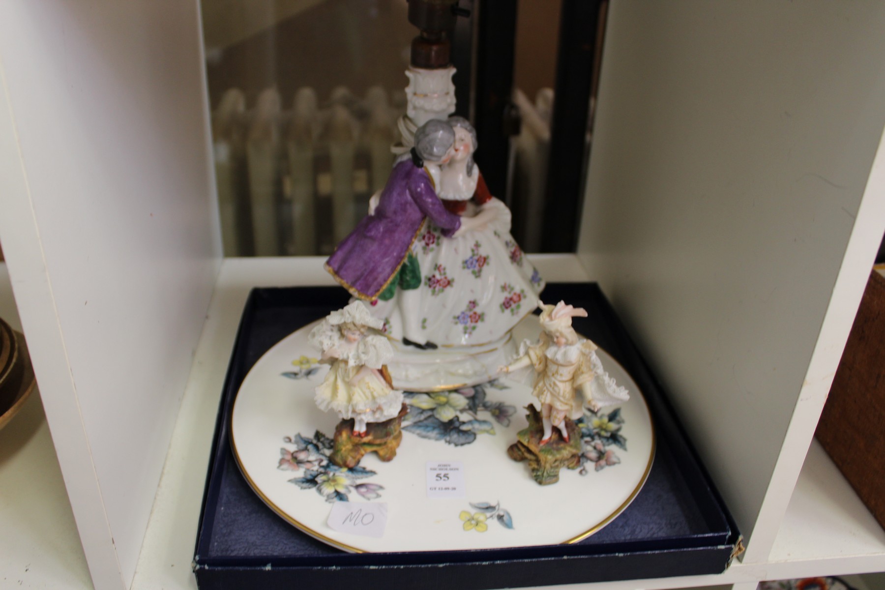 A porcelain figural lamp, a pair of figures and a boxed porcelain stand.