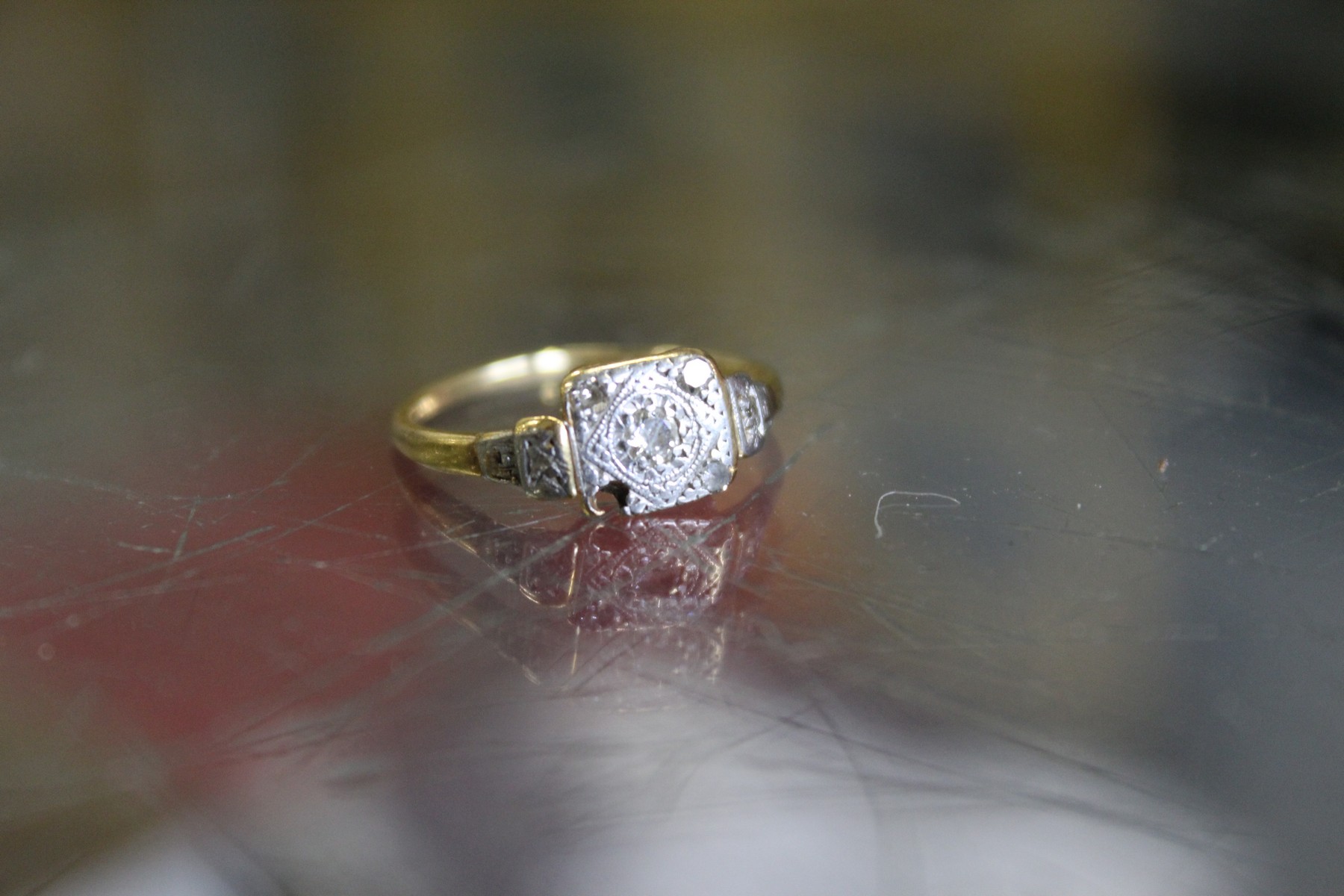 A gold and diamond ring (lacking one diamond).