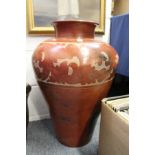 A large floor standing terracotta vase with painted decoration.