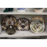 A small group of decorative plates and a moulded glass dish.