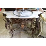 A wrought iron and marble top serpentine shaped console table.