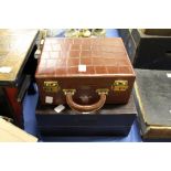 A crocodile style leather vanity case and a wooden games box.