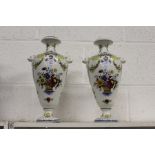 A pair of continental floral decorated porcelain vases.