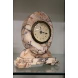 An alabaster cased oval mantle clock.