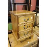 A pine three drawer bedside chest.