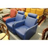 A good pair of Heal's blue leather upholstered reclining armchairs.