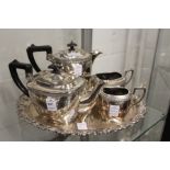 A four piece tea service and a plated tray.