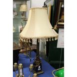 A Corinthian column style table lamp with shade.