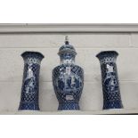 Chinese style blue and white decorated garniture comprising a lidded vase and a pair of sleeve