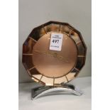 An Art Deco pink glass mantle clock.