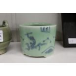 An oriental blue and celadon glazed tripod censer.