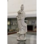A small Chinese blanc-de-chine figure of Guanyin.