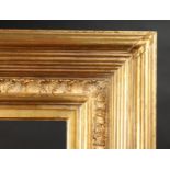 A Shaped and Composition Gilt Frame, 33.25" x 52.25" - 84.5cm x 132.75cm to slip. 34.75" x 54" -