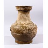 A GOOD CHINESE HAN DYNASTY TWIN HANDLE VASE, the vase with naturalistic remains, twin archaic handle