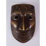 A GOOD 19TH / 20TH CENTURY PERSIAN BRONZE CALLIGRAPHIC MASK, with carved panels of calligraphy and