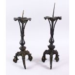 A PAIR OF CHINESE MING BRONZE ALTER / CANDLE STICKS, with lotus form base, on three lion dog moulded