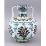 A CHINESE DOUCAI PORCELAIN TWIN HANDLE VASE, the body decorated with sprays of flora, twin moulded