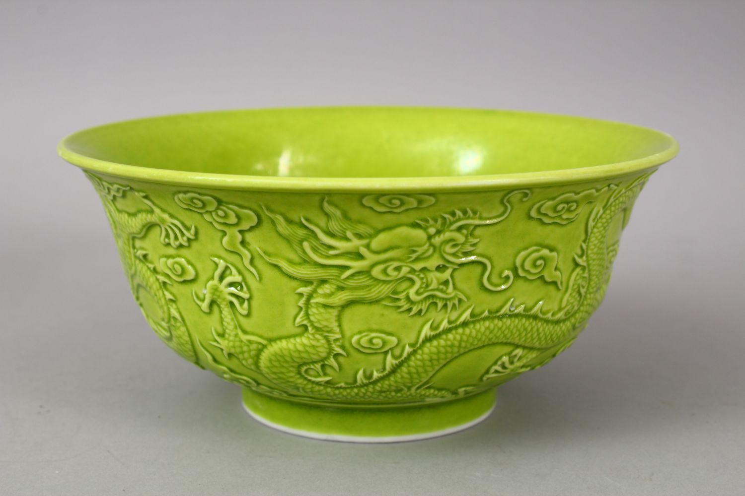 A CHINESE GREEN GLAZED PORCELAIN DRAGON BOWL, with moulded decoration of dragons amongst stylized - Image 4 of 6