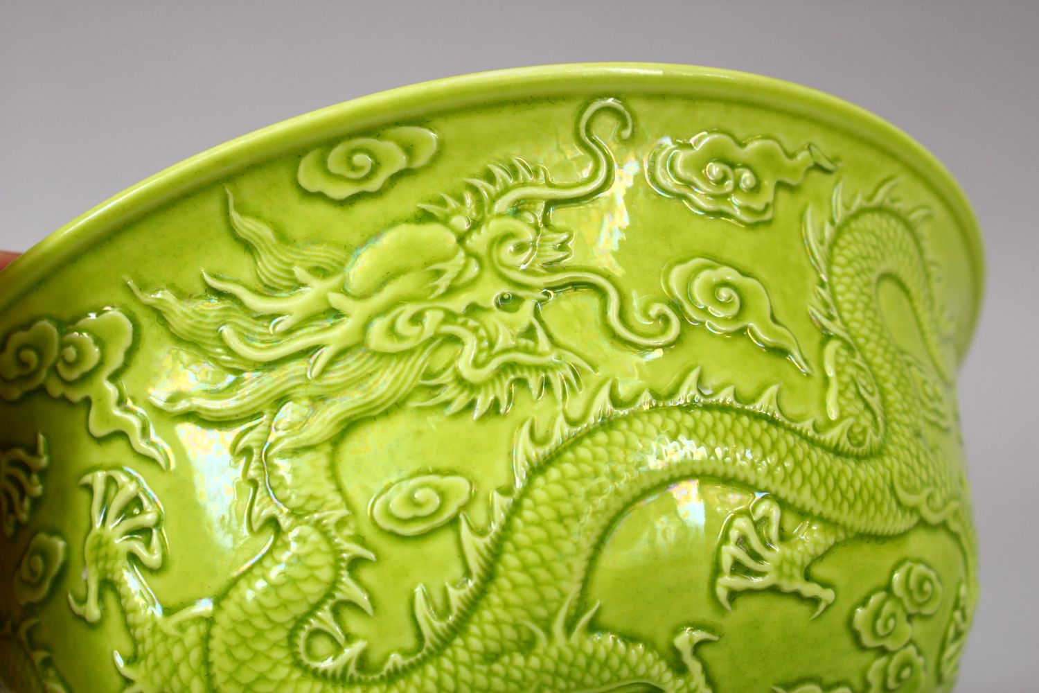 A CHINESE GREEN GLAZED PORCELAIN DRAGON BOWL, with moulded decoration of dragons amongst stylized - Image 5 of 6