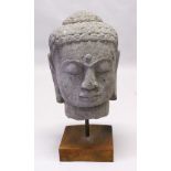 A GOOD 19TH / 20TH CENTURY LARGE CARVED GANDHARA STONE BUST OF A HEAD, on a fitted wooden stand,