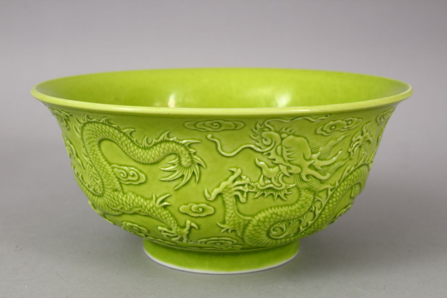 A CHINESE GREEN GLAZED PORCELAIN DRAGON BOWL, with moulded decoration of dragons amongst stylized - Image 3 of 6