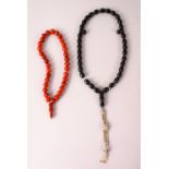 TWO ISLAMIC PRAYER / ROSARY BEADS, possibly Bakelite, 26cm & 31cm.