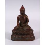 A CHINESE TIBETAN BRONZE FIGURE OF A SEATED BUDDHA, with traces of lacquer, seated upon lotus,