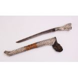 A GOOD ISLAMIC SILVER MOULDED DAGGER, the dagger with silver embossed sheath and hilt, with carved