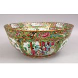 A LARGE 19TH CENTURY CHINESE CANTON FAMILLE ROSE PORCELAIN BOWL, with panel decoration of figures,