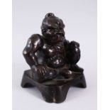 A GOOD JAPANESE MEIJI PERIOD BRONZE FIGURE OF SEATED ONI, in a seated position with a meaningful